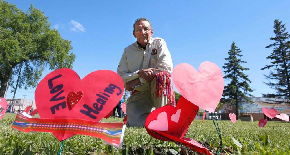 WAYNE GLOWACKI / WINNIPEG FREE PRESS
George Lavallee spoke about his painful residential school experiences at the Metis Red Heart Ceremony on June 20 to recognize Metis Residential and Day School Survivors. About 100 attended the ceremony held beside the MMF building placing paper hearts in the ground with messages to honour and recognize residential and day school survivors.