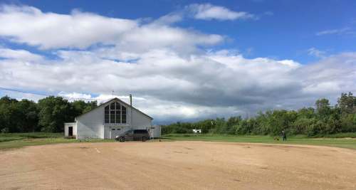 MELISSA MARTIN / WINNIPEG FREE PRESS
Floyd Lavallee mowing the lawn in front of the rickety old nameless church, which still holds mass on Sundays.