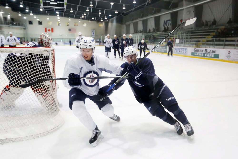 JUSTIN SAMANSKI-LANGILLE / WINNIPEG FREE PRESS
Luke Green, left, battles Skyler McKenzie for possession of the puck during a drill at Wednesday's Jets development camp.