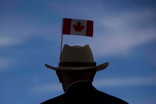 Darryl Dyck
/ The Canadian Press
Errol Yim, 92, wears a Canadian flag on his hat as he takes in the view of the harbour during Canada Day celebrations in Vancouver, B.C., on Tuesday July 1, 2014.