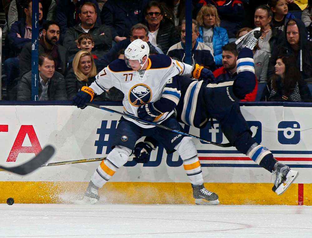 ADAM CAIRNS / TRIBUNE MEDIA FILE
The Columbus Blue Jackets' Boone Jenner is checked into the boards by the Buffalo Sabres' Dmitry Kulikov in a game at Nationwide Arena in Columbus, Ohio, in March.