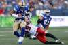 THE CANADIAN PRESS/John Woods
Winnipeg Blue Bombers' Andrew Harris breaks a tackle by Calgary Stampeders' Alex Singleton during the first half.