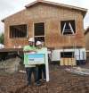 MIKE DEAL / WINNIPEG FREE PRESS
The worksite is buzzing despite the rain. Charles and Christine Harper will soon own a Habitat home.
