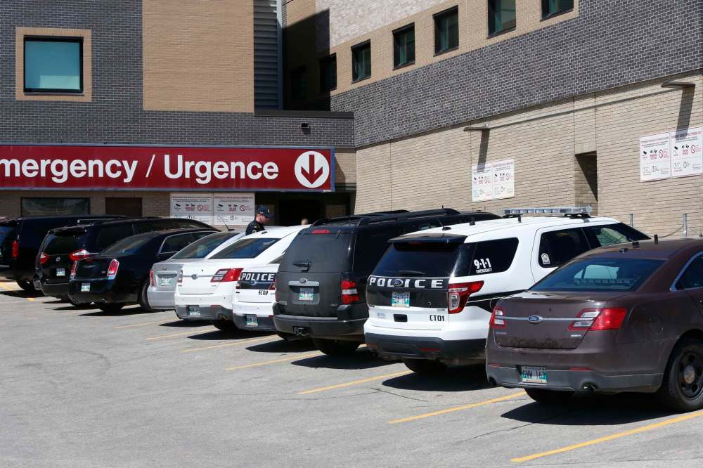 Vehicles in former U.S. President Jimmy Carter's motorcade and Winnipeg police vehicles are seen outside the emergency department at St. Boniface Hospital Thursday. (Wayne Glowacki / Winnipeg Free Press)
