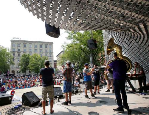 Wayne Glowacki / Winnipeg Free Press
The Dirty Catfish Brass Band perform in the cube for Lunchtime Winnipeg Fringe Festival entertainment at Market Square in Winnipeg's Exchange District last week. The cumulative total of ticketed attendance in the first five days of the fest came in at 41,301, only slightly behind the 2015 record.