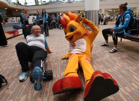 JOE BRYKSA / WINNIPEG FREE PRESSTeam Nova Scotia track and field athlete Taylor Stutely, 21, does some stretches with Canada games mascot Niibin as team Nova Scotia athletes arrive in Winnipeg.
