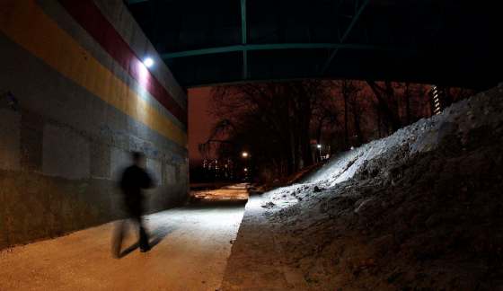 MIKE DEAL / WINNIPEG FREE PRESS FILESA pedestrian on an early evening walk on the River Walk that follows the Assiniboine River just east of the Donald Street Bridge where a sixteen-year-old girl was attacked by two men.
