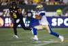 PHOTOS BY AARON LYNETT / THE CANADIAN PRESS
Winnipeg Blue Bombers running back Andrew Harris, right, runs the ball past Hamilton Tiger-Cats defensive back Khalid Wooten in fourth-quarter CFL action in Hamilton, Ont., on Saturday.