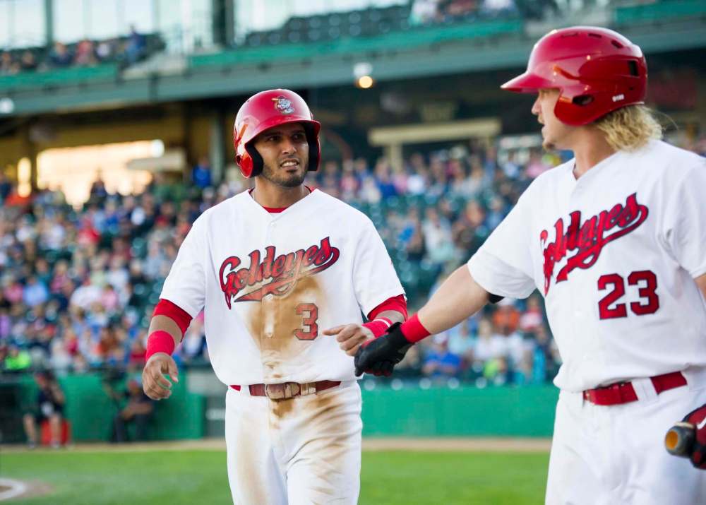 DAVID LIPNOWSKI / WINNIPEG FREE PRESS FILES
Winnipeg Goldeye Maikol Gonzalez (left) celebrates a run with teammate Josh Romanski in a game against the Sioux City Explorers at Shaw Park.