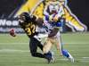 THE CANADIAN PRESS/Aaron Lynett
Hamilton Tiger-Cats running back C.J. Gable is hit by Blue Bombers defensive tackle Cory Johnson in Hamilton, Saturday.