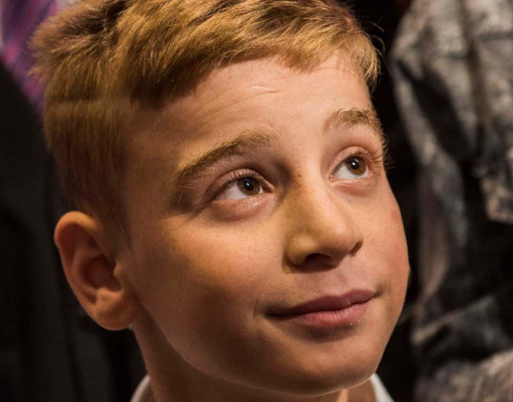 David Lipnowski / The Canadian Press
Emad Mishko Tamo, 12, looks on as he’s reunited with friends and family at Richardson International Airport.