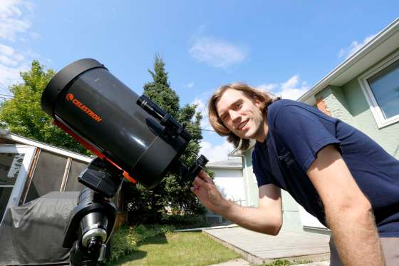 JUSTIN SAMANSKI-LANGILLE / WINNIPEG FREE PRESSBrenden Petracek, president of the Winnipeg chapter of the Royal Astronomical Society of Canada, poses with one of his telescopes. Petracek is driving to Nebraska to see the total eclipse.