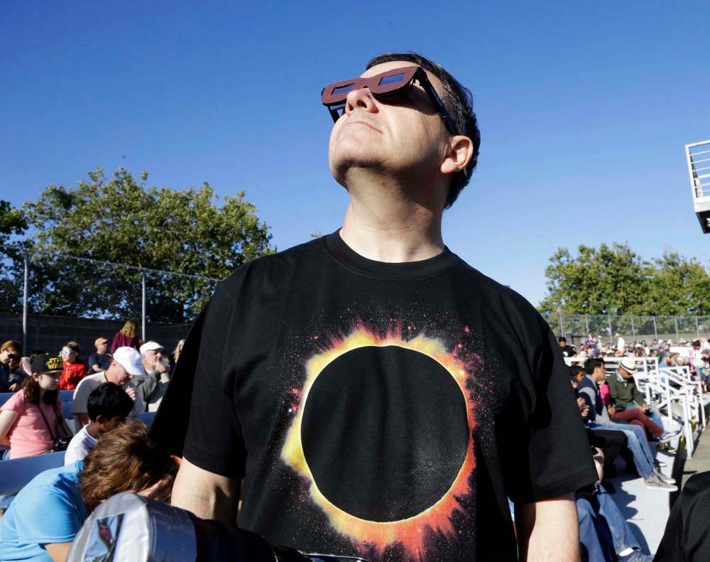 Don Ryan / The Associated Press
An eclipse watcher looks skyward in Oregon.