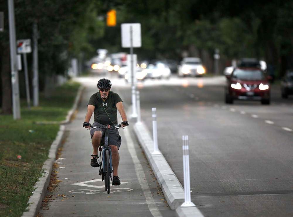 PHIL HOSSACK / WINNIPEG FREE PRESS
A cyclist makes his way up Sherbrook Street behind a short strip of protective curbs.
