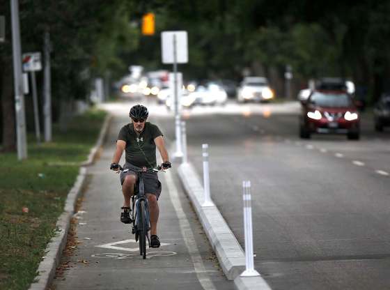 PHIL HOSSACK / WINNIPEG FREE PRESSA cyclist makes his way up Sherbrook Street behind a short strip of protective curbs.