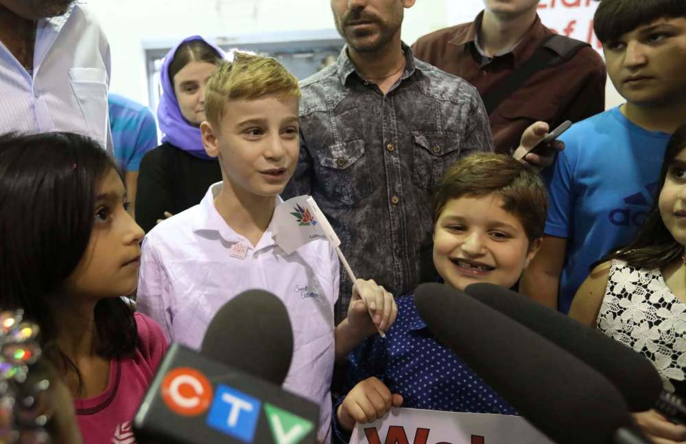 RUTH BONNEVILLE / WINNIPEG FREE PRESS
12-year-old Emad Tamo speaks to the crowd of friends, family and media that surrounds him at the Crescentwood Community Centre during a celebration held for him by the Yazidi Association of Manitoba, Thursday evening.