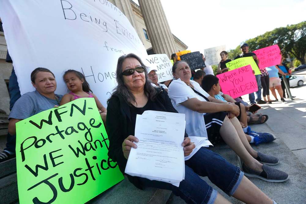 JOHN WOODS / WINNIPEG FREE PRESS FILES
Donna Gabriel, from Portage la Prairie, holds eviction notices received in August during a demonstration.