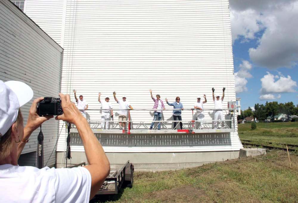 Ian Froese / Brandon Sun
Painters giving a fresh coat of paint to the United Grain Growers elevator in Inglis pose for the camera.