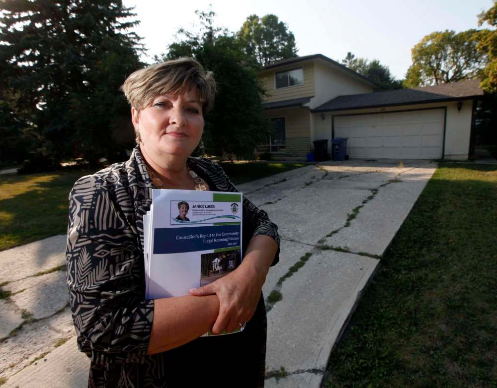 PHIL HOSSACK / WINNIPEG FREE PRESS
Coun. Janice Lukes stands in front of a Thatcher Drive house used as an illegal rooming house, holding a report on the issue that will be released this morning.
