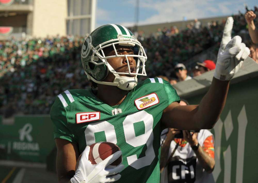 Saskatchewan Roughriders wide receiver Duron Carter celebrates a touchdown by taunting Winnipeg Blue Bombers fans during first half CFL action in Regina on Sunday, September 3, 2017. On Monday, Carter accused a visiting Winnipeg fan wearing blue and gold facepaint of spitting on him as he celebrated a second-quarter touchdown in Mosaic Stadium's south end zone. (Mark Taylor / The Canadian Press)