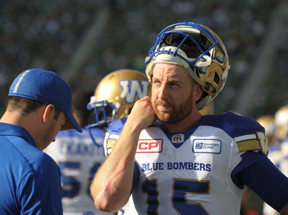 MARK TAYLOR / THE CANADIAN PRESS
Winnipeg Blue Bombers quarterback Matt Nichols checks out the scoreboard as a trainer patches him up during second half CFL action against the Saskatchewan Roughriders.