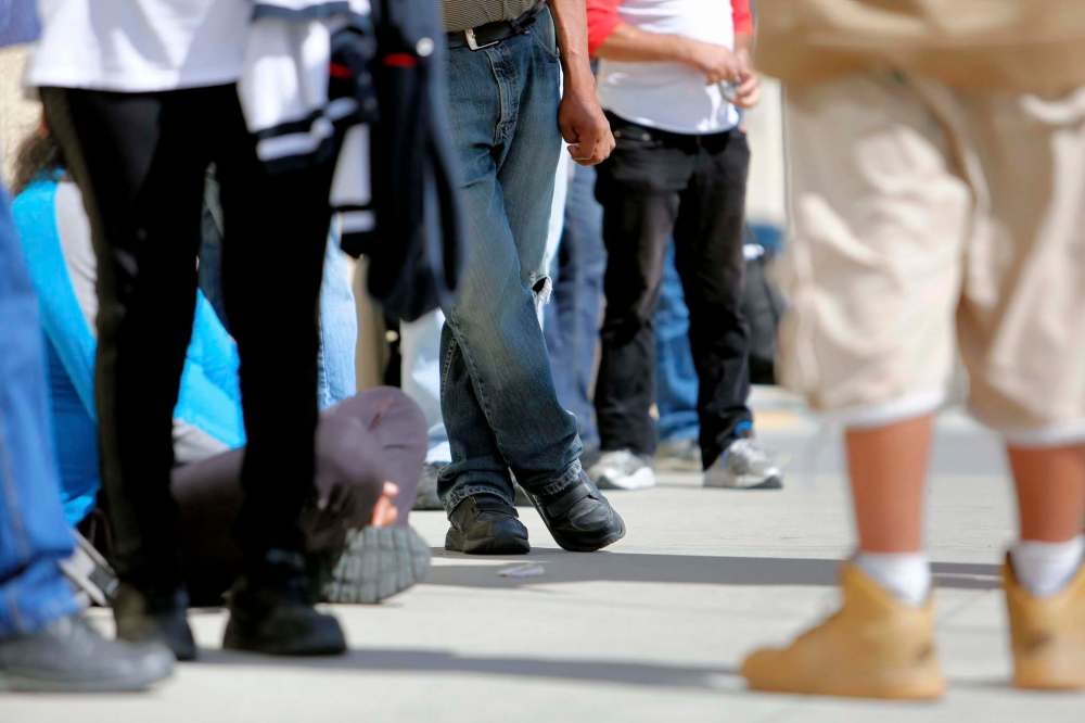 JUSTIN SAMANSKI-LANGILLE / WINNIPEG FREE PRESS FILES
People line up in front of Siloam Mission. More than 60,000 Manitobans were helped by food banks last year, a 53 per cent jump from 2008.