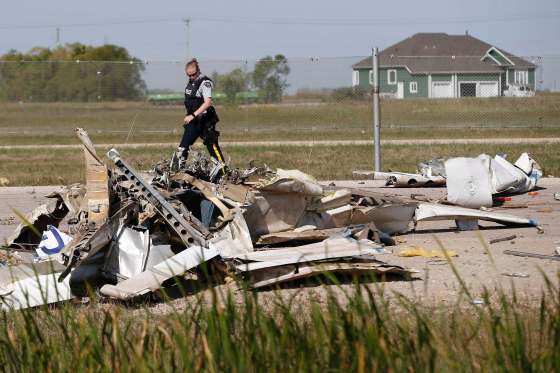 John Woods / The Canadian PressRCMP investigate at the scene of a fatal plane crash at St. Andrews Airport, north of Winnipeg, Thursday.