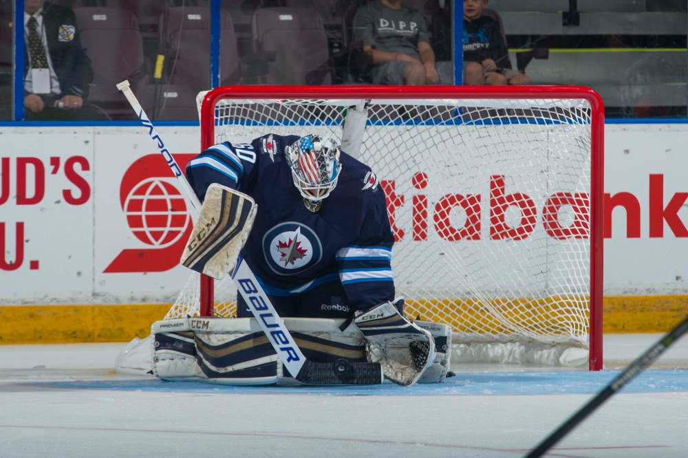 Marissa Baecker/Shoot the Breeze
Mikhail Berdin #60 of the Winnipeg Jets makes a stick save against the Vancouver Canucks on September 8, 2017 at the South Okanagan Event Centre in Penticton.