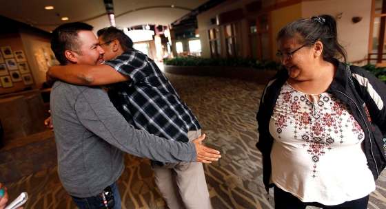 PHIL HOSSACK / WINNIPEG FREE PRESS filesGarden Hill Chief Dino Flett (left) welcomes Lloyd and Margaret Little at a Red Cross reception area at Canad Inns Polo Park for refugees fleeing norther fires in Manitoba on Aug. 30.