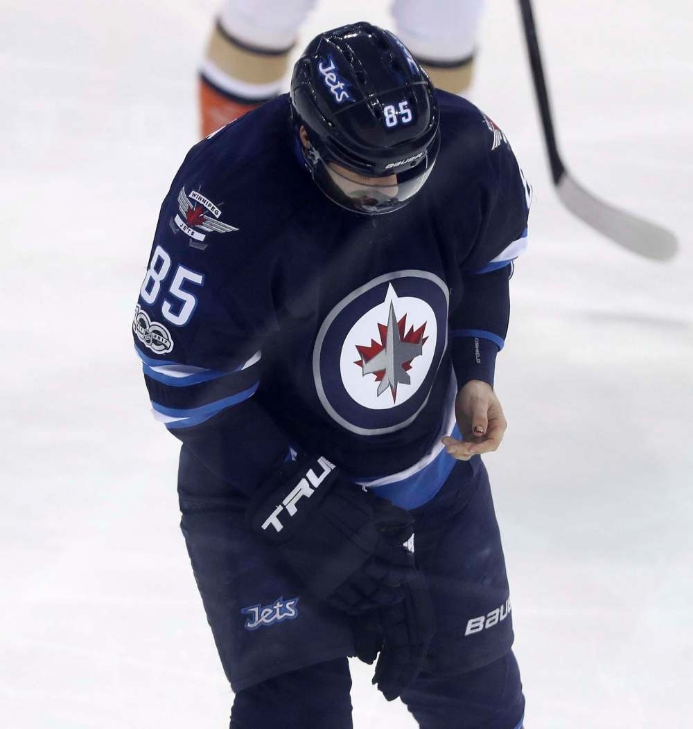 THE CANADIAN PRESS/Trevor Hagan
Winnipeg Jets' Mathieu Perreault bleeds from his thumb after taking a slash by Anaheim Ducks' Corey Perry during a game in Winnipeg, January 2017.