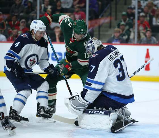 (Jeff Wheeler/Minneapolis Star Tribune/TNS)The Minnesota Wild's Marcus Foligno tries to shove the puck between the pads of Winnipeg Jets goalie Connor Hellebuyck in the first period of their pre-season game on Thursday at Xcel Energy Center in St. Paul, Minn.