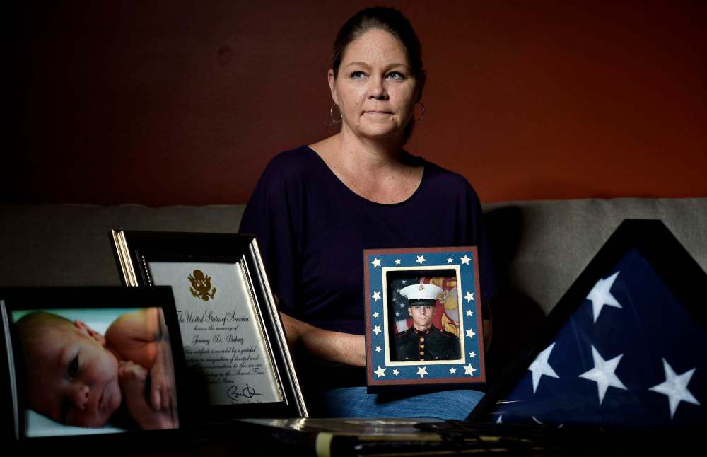 Rich Sugg / Kansas City Star
Stephanie Price holds a portrait of her son, Jeromy Bubacz, who had been fighting prescription-drug addiction for years. Bubacz overdosed on a vast supply of pills he was prescribed after a relatively minor procedure in a hospital.