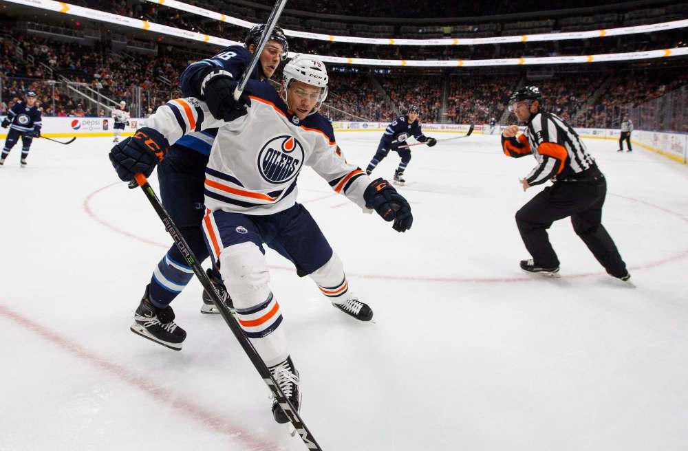 Winnipeg Jets' Brendan Lemieux (48) and Edmonton Oilers' Dillon Simpson (79) battle in the corner during third period pre-season NHL action in Edmonton, Alta., on Saturday September 23, 2017. (Jason Franson / The Canadian Press files)