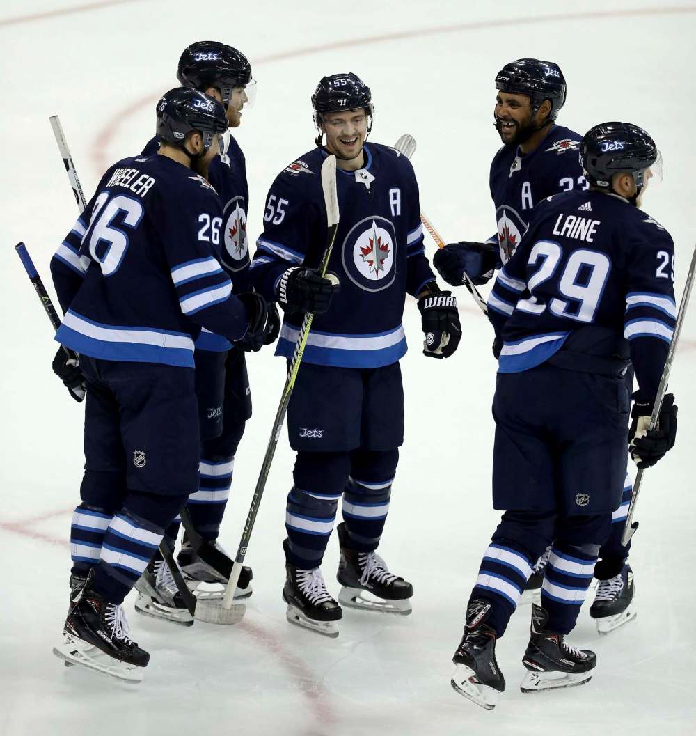 THE CANADIAN PRESS/Trevor Hagan
Winnipeg Jets' Blake Wheeler, Adam Lowry, Mark Scheifele, Dustin Byfuglien and Patrik Laine celebrate after Laine scored against the Calgary Flames' during first period preseason NHL hockey action in Winnipeg, Monday, September 25, 2017.