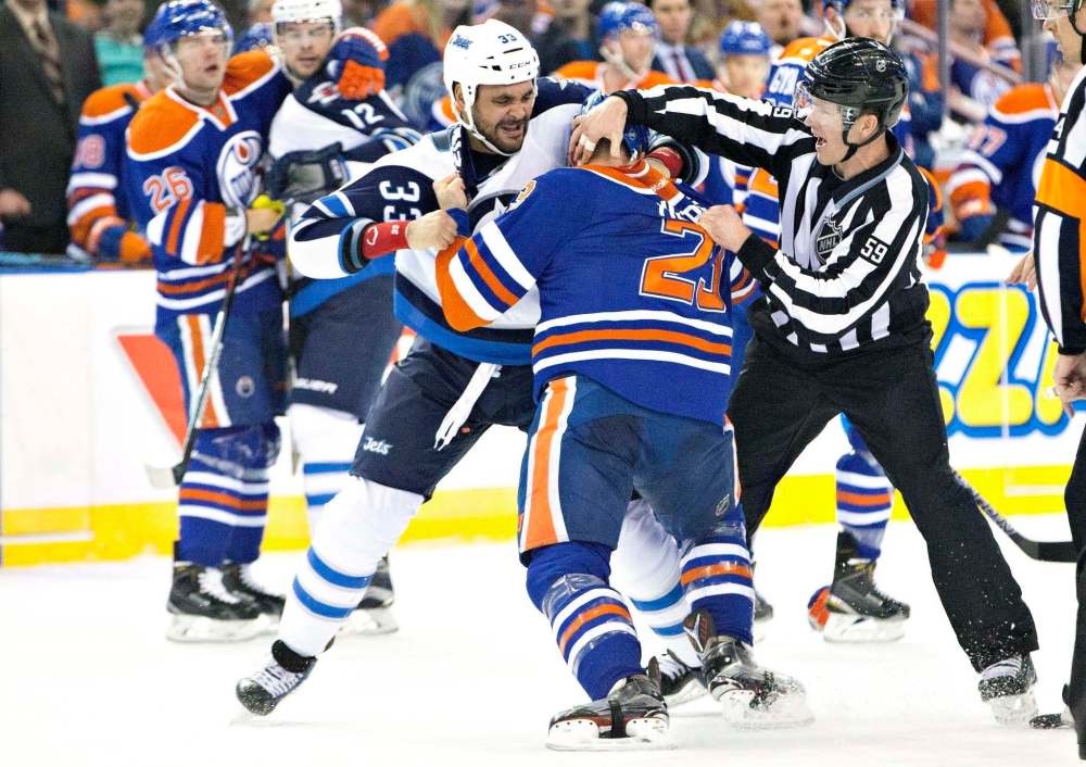 THE CANADIAN PRESS/Jason Franson
Winnipeg Jets' Dustin Byfuglien fights then- Edmonton Oilers' Matt Hendricks during a game in February, 2016. With no designated team fighter, the two players (now Jets teammates) may be called upon more often to stand up for other Jets' players by fighting – just not with eachother.