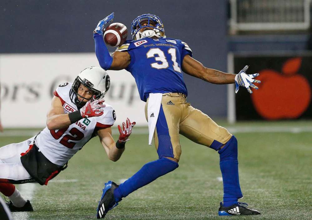 THE CANADIAN PRESS/John Woods
Maurice Leggett intercepts the pass intended for Ottawa Redblacks' Greg Ellingson during the second half of their game last Friday. In 10 games so far this season, Leggett has three interceptions and 43 defensive tackles.