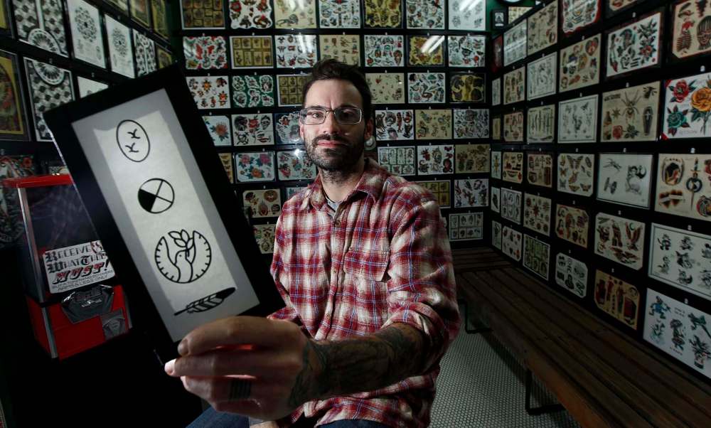 PHIL HOSSACK / WINNIPEG FREE PRESS
Bram Adey, tattoo artist at Rebel Waltz Tattoo, has a sheet of tattoo designs developed for Errol Greene.
