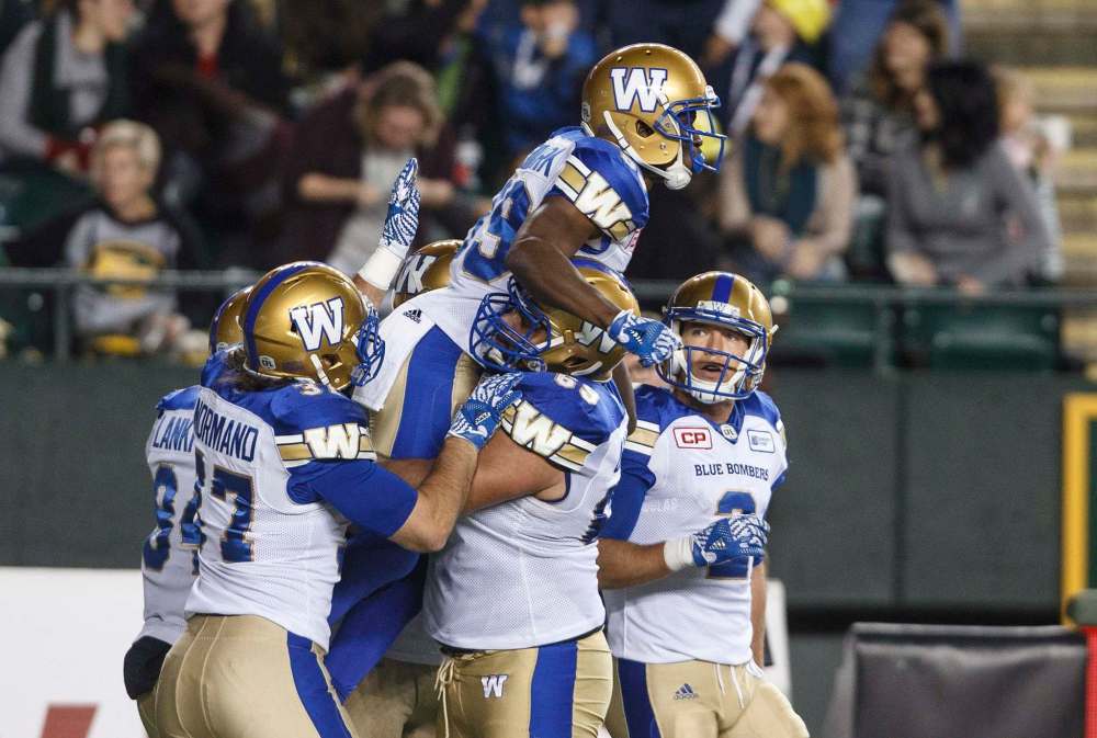 Jason Franson / The Canadian Press
Winnipeg Blue Bombers players celebrate a touchdown against the Edmonton Eskimos in Edmonton on Saturday.