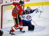 Jeff McIntosh / The Canadian Press
Jets goalie Steve Mason (right) deflects the puck as the Flames’ Troy Brouwer tries for a rebound. Mason allowed two goals on 33 shots going into the shootout.