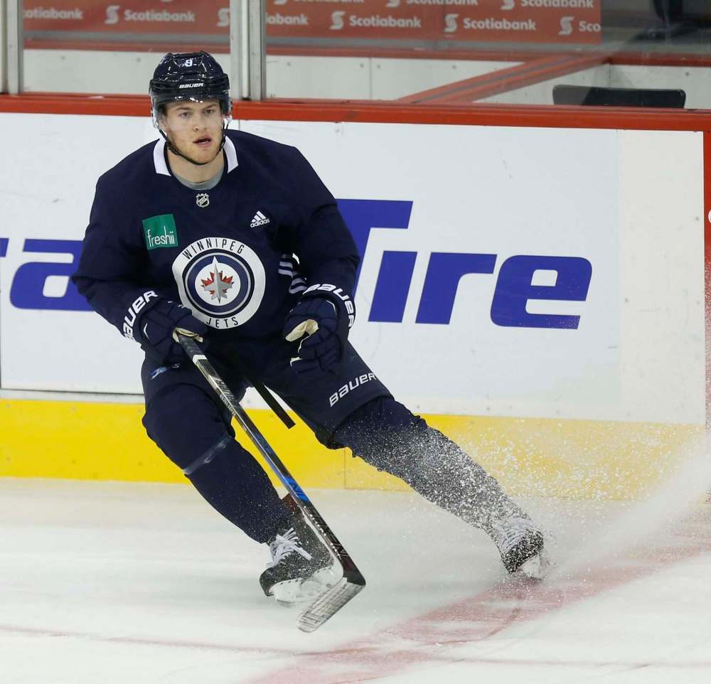 Andrew Copp took a slapshot to an unprotected area of his right knee Saturday night in Calgary and was sidelined for a couple of days, but he was back on the ice this morning. (Wayne Glowacki / Winnipeg Free Press)
