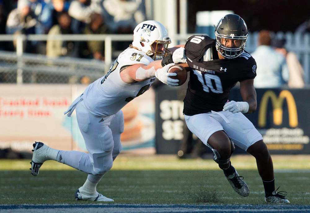 L. TODD SPENCER / ASSOCIATED PRESS FILES
Old Dominion's David Washington (10) runs away from Florida International's Newton Salisbury during the first half game of an NCAA college football game last November in Norfolk, Va.