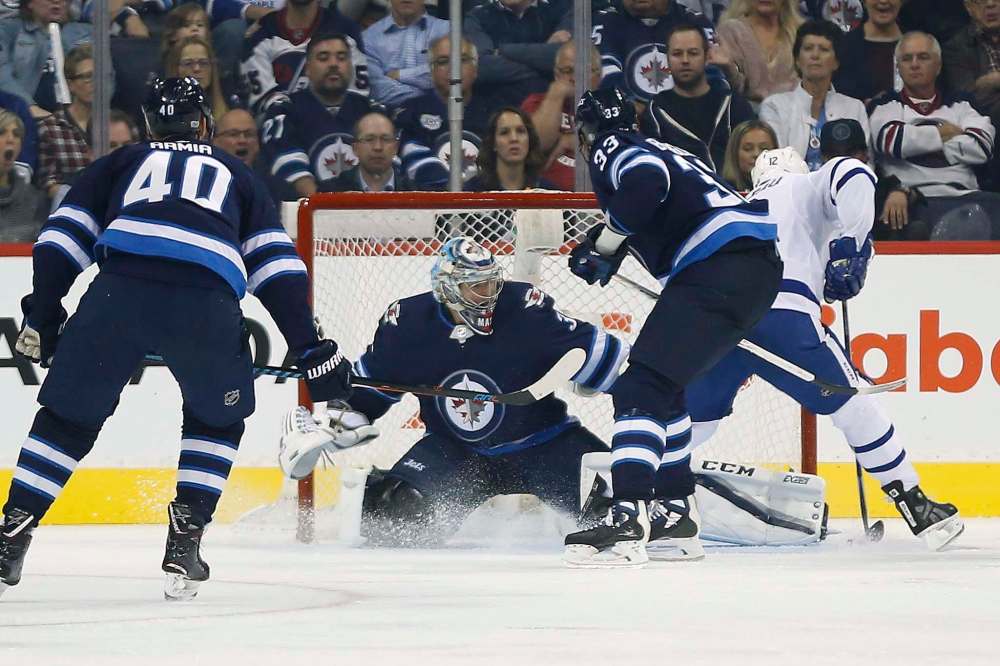 THE CANADIAN PRESS/John Woods
Toronto Maple Leafs' Patrick Marleau scores on Winnipeg Jets goaltender Steve Mason as Joel Armia and Dustin Byfuglien defend during second period NHL action in Winnipeg on Wednesday, October 4, 2017.