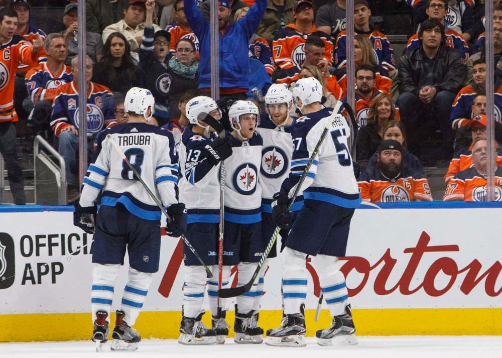 JASON FRANSON / THE CANADIAN PRESS
Winnipeg Jet Nikolaj Ehlers (27) celebrates his goal with teammates Jacob Trouba (8), Brandon Tanev (13), Adam Lowry (17) and Tyler Myers (57) during second-period NHL action against the Edmonton Oilers in Edmonton Monday.