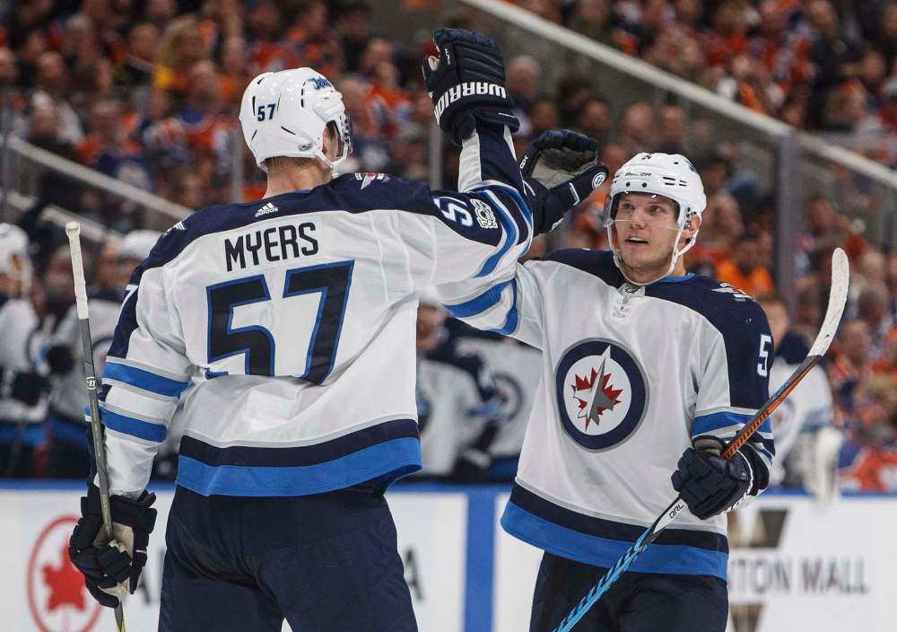 JASON FRANSON / THE CANADIAN PRESS
Winnipeg Jets' Tyler Myers (57) and Dmitry Kulikov (5) celebrate a goal against the Edmonton Oilers during the first period in Edmonton Monday.