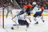 THE CANADIAN PRESS/Jason Franson
Winnipeg Jets goalie Connor Hellebuyck makes a save as Edmonton Oilers' Iiro Pakarinen and Tucker Poolman battle in front of the net during second period NHL action in Edmonton, Monday. Poolman drew into his first regular season NHL game as a result of an injury to veteran blue-liner Dustin Byfuglien.