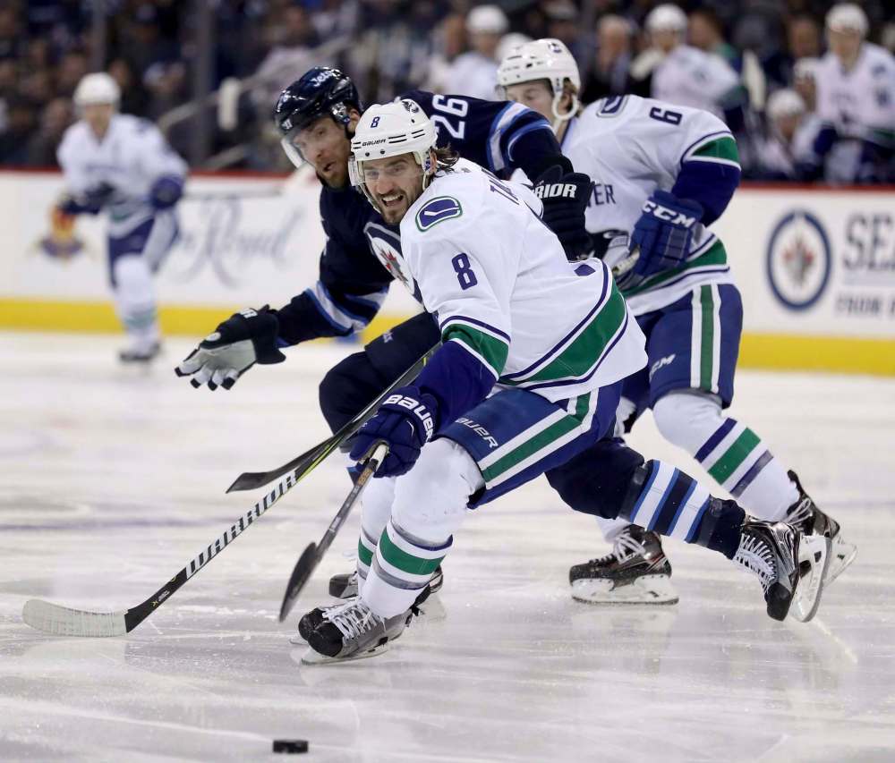 Trevor Hagan / The Canadian Press files
Vancouver Canucks’ Christopher Tanev keeps the puck away from Winnipeg Jets’ Blake Wheeler.
