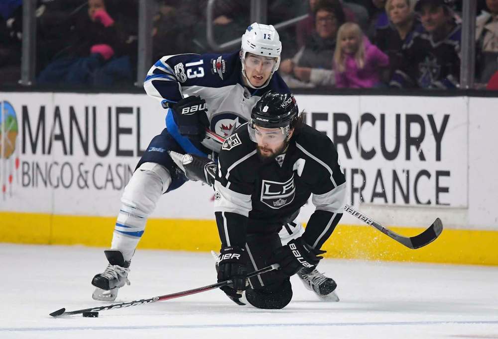 Mark J. Terrill / The Associated Press Files
Los Angeles Kings defenseman Drew Doughty, right, is pushed down by Winnipeg Jets left wing Brandon Tanev.