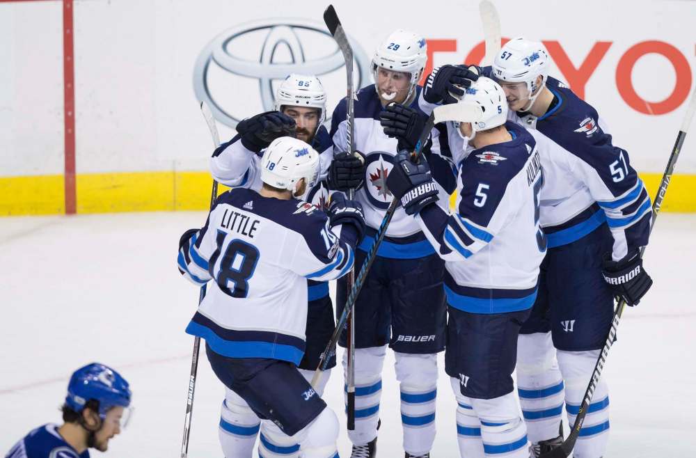 THE CANADIAN PRESS / Darryl Dyck
Winnipeg Jets' Bryan Little, from left to right, Mathieu Perreault, Patrik Laine, Dmitry Kulikov and Tyler Myers celebrate Laine's goal against the Vancouver Canucks during the second period of their NHL hockey game in Vancouver, B.C., on Thursday.