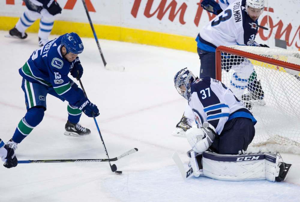 THE CANADIAN PRESS/Darryl Dyck
Vancouver Canucks' Derek Dorsett, left, is stopped by Winnipeg Jets' goalie Connor Hellebuyck who had 31 saves on the night.