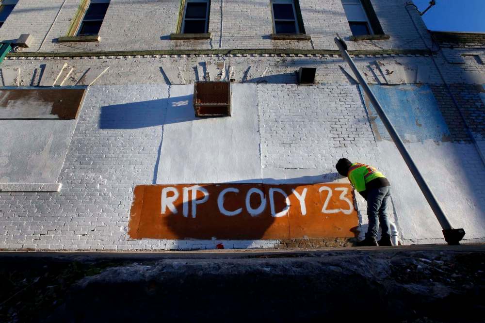 WAYNE GLOWACKI / WINNIPEG FREE PRESS
Jasmine Kabestra-Savage writes a message on the side of the Sutherland Hotel Friday morning in memory of her friend Cody Severight, who was killed Tuesday while crossing Main Street.
